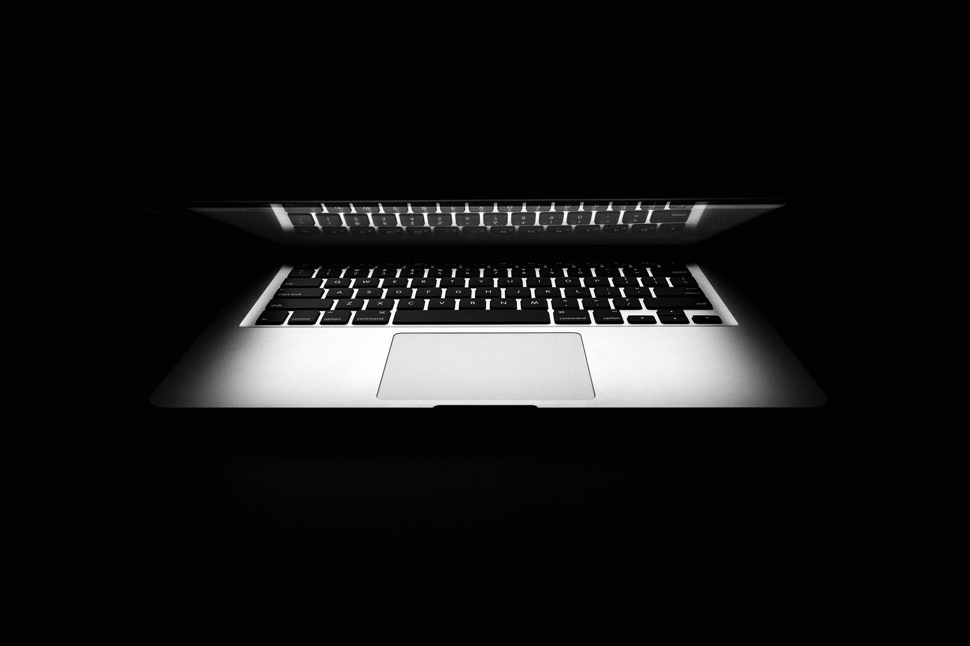 Close-up of a laptop keyboard with RGB backlighting — the modern AI workstation